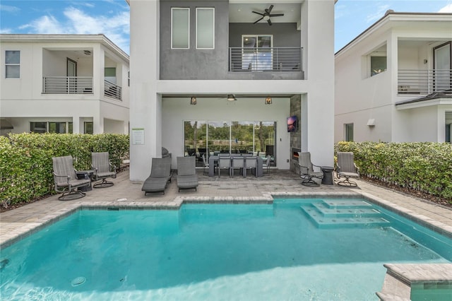 rear view of house featuring central AC unit, ceiling fan, a fenced in pool, and a patio