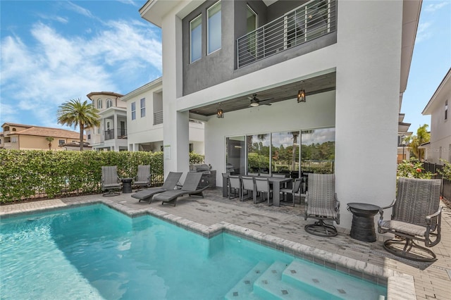 view of pool with ceiling fan and a patio