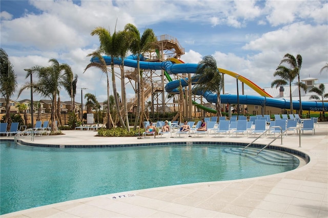 view of swimming pool featuring a patio area and a water slide