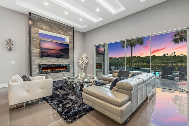 living room with a large fireplace and light tile patterned floors