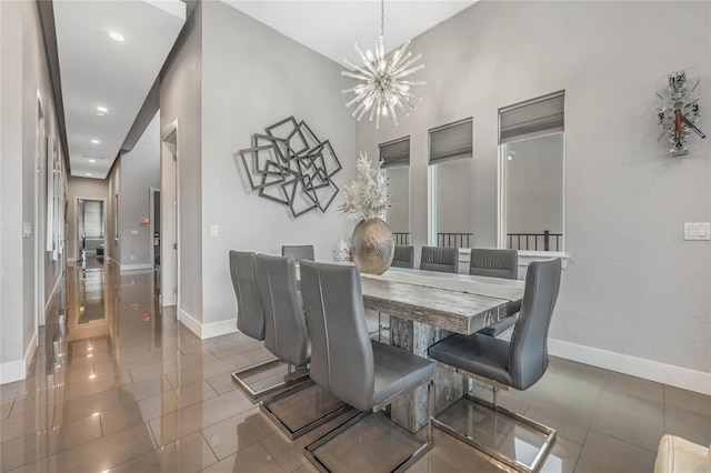 dining room with tile patterned floors and an inviting chandelier