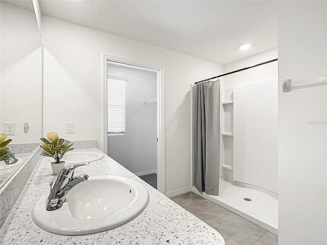 bathroom featuring vanity, tile patterned floors, and walk in shower