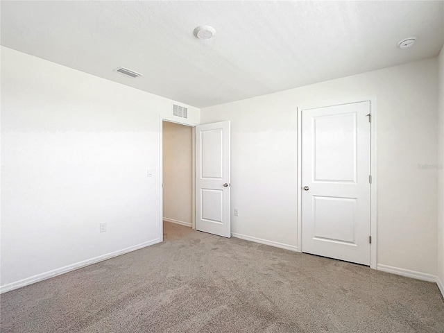 unfurnished bedroom featuring light colored carpet