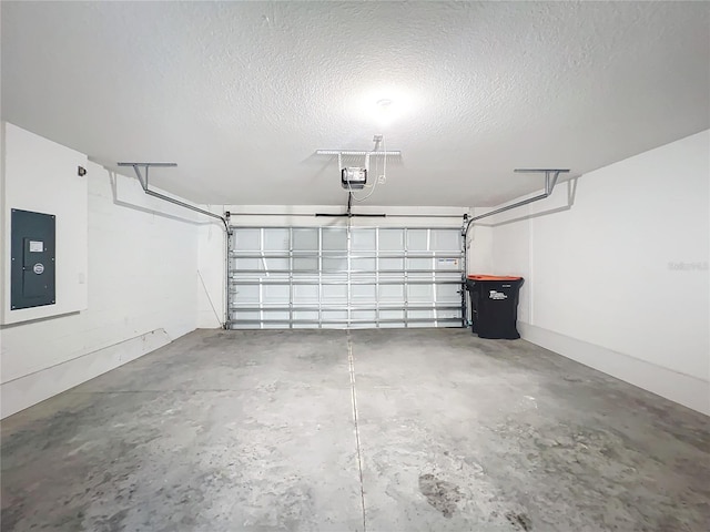 garage with a garage door opener and electric panel