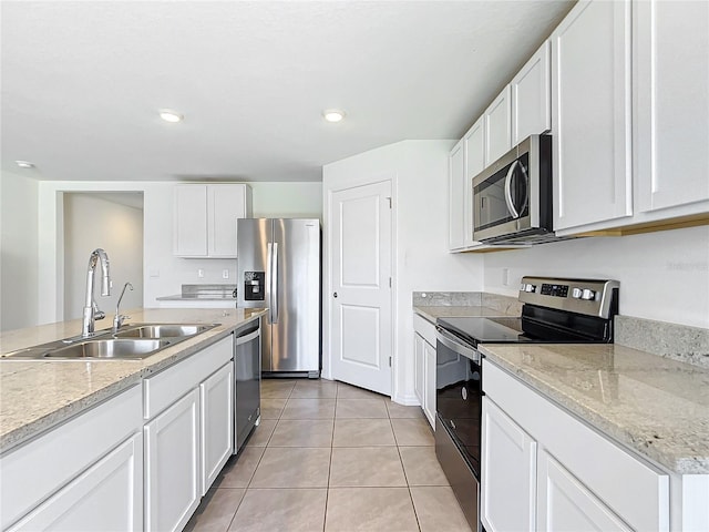 kitchen with white cabinetry, appliances with stainless steel finishes, sink, and light tile patterned floors