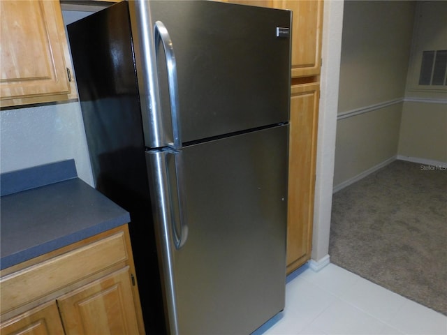 kitchen featuring stainless steel fridge and light carpet