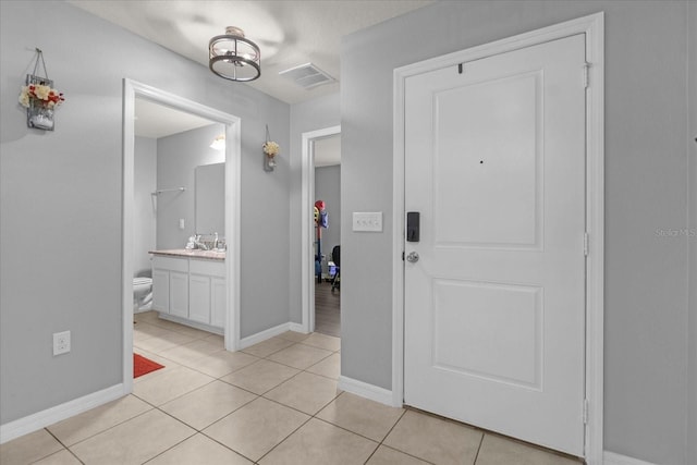 foyer with light tile patterned floors