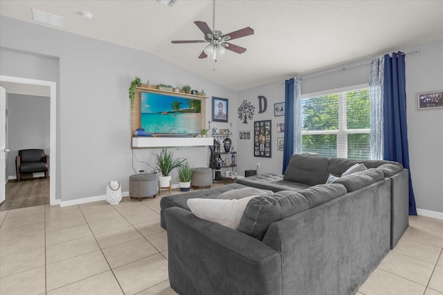 living room featuring ceiling fan, light tile patterned flooring, and vaulted ceiling