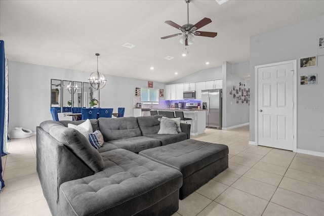 tiled living room with ceiling fan with notable chandelier and lofted ceiling