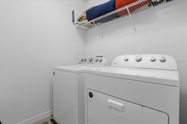 clothes washing area with separate washer and dryer