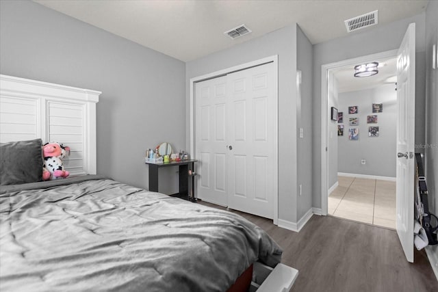 bedroom with a closet and dark wood-type flooring