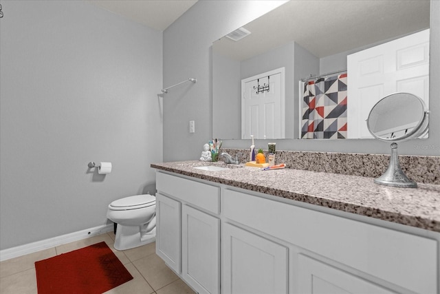 bathroom featuring curtained shower, tile patterned flooring, vanity, and toilet