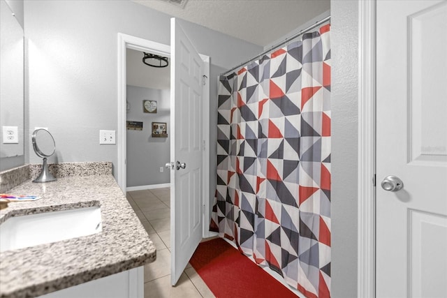 bathroom featuring tile patterned flooring and vanity