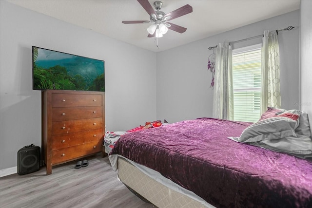 bedroom with ceiling fan and light wood-type flooring