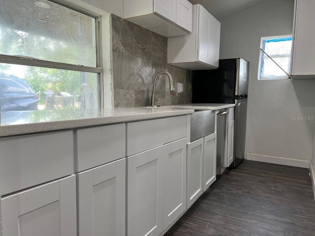 1526 Lakewood Rd, Davenport, FL 33837 - kitchen featuring dark wood-style flooring, backsplash, white cabinetry, lofted ceiling, and stainless steel dishwasher
