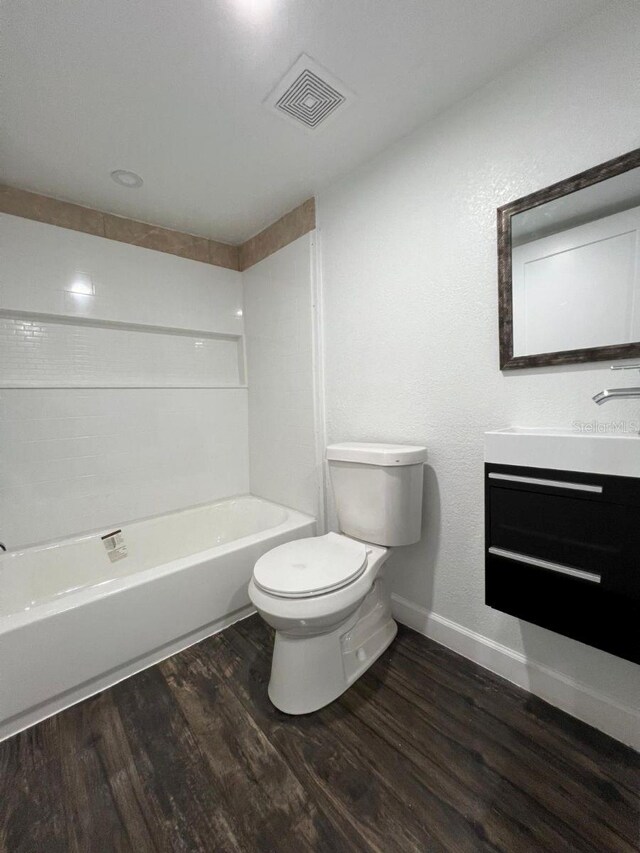 full bathroom featuring shower / bath combination, vanity, toilet, and wood-type flooring