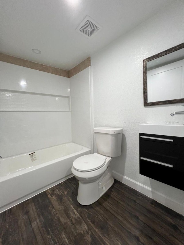 1526 Lakewood Rd, Davenport, FL 33837 - full bathroom featuring vanity, wood finished floors, and shower / washtub combination