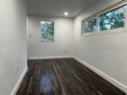 empty room featuring dark wood-type flooring