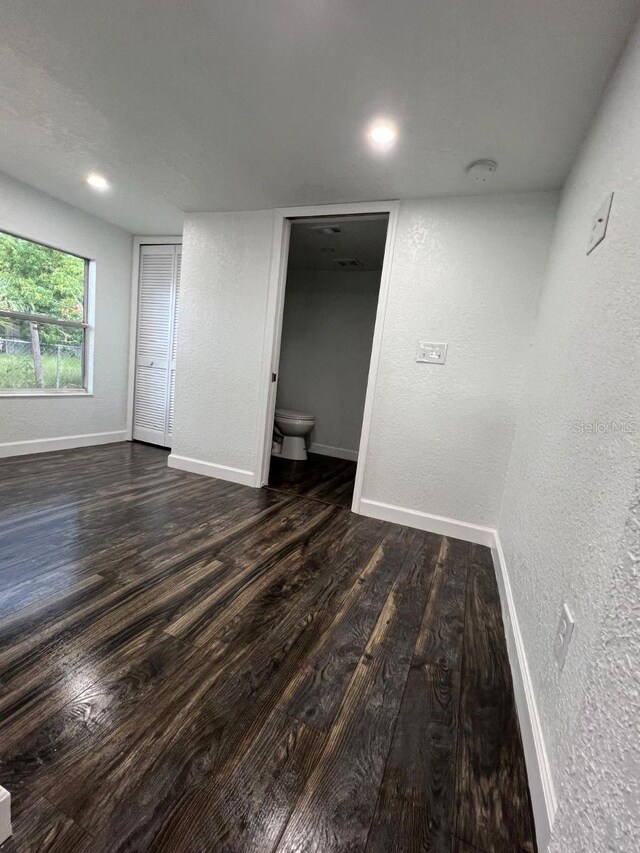 unfurnished room with dark hardwood / wood-style floors