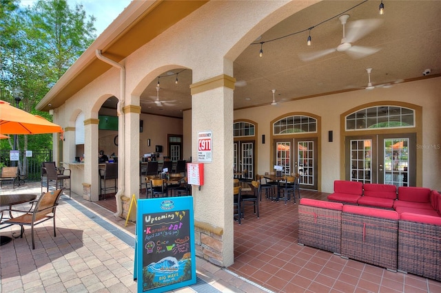 view of terrace with ceiling fan, french doors, and an outdoor hangout area