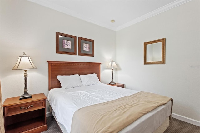 bedroom with ornamental molding and dark carpet