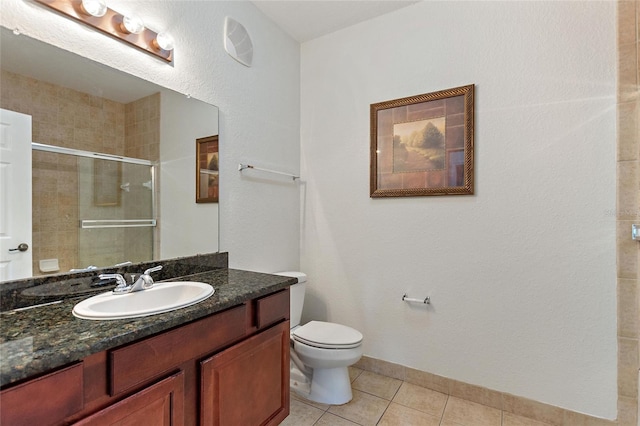 bathroom featuring tile floors, toilet, and large vanity