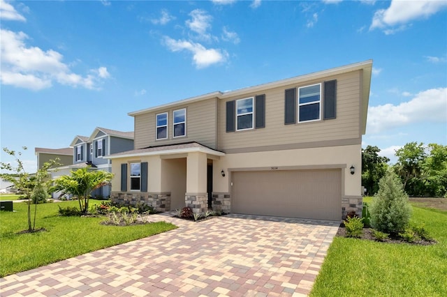 view of front of home with a garage and a front lawn