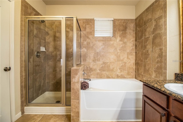 bathroom featuring shower with separate bathtub, vanity, and tile patterned flooring