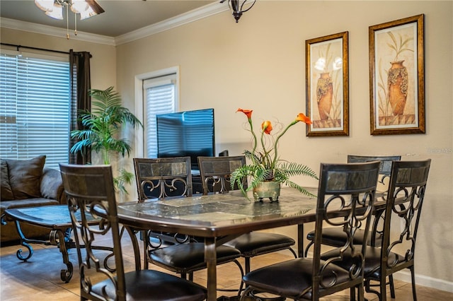 tiled dining area featuring ceiling fan, plenty of natural light, and crown molding