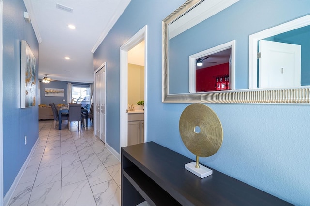 corridor with crown molding and sink