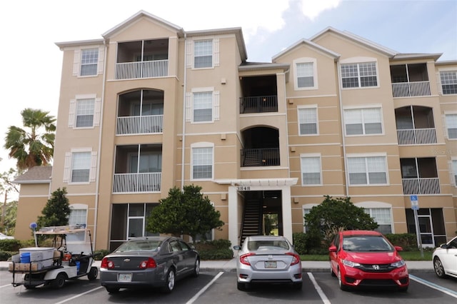 view of building exterior featuring uncovered parking