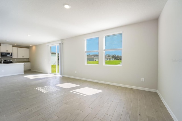 unfurnished living room featuring light hardwood / wood-style floors