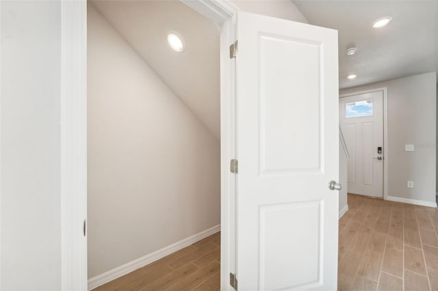 corridor with light hardwood / wood-style floors