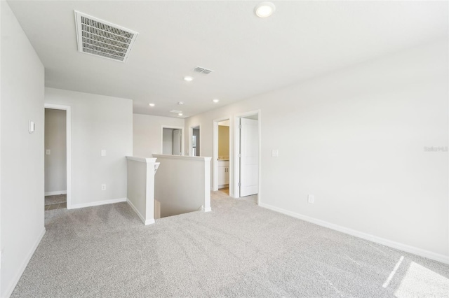 spare room featuring light colored carpet