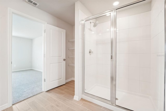 bathroom featuring a shower with shower door