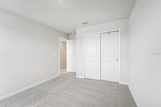 unfurnished bedroom featuring a closet and carpet floors