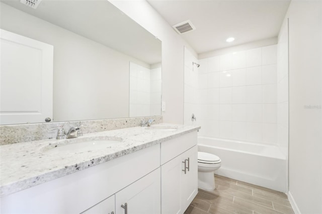 full bathroom featuring vanity, toilet, and tiled shower / bath