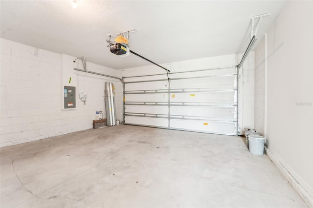 garage featuring electric panel and a garage door opener