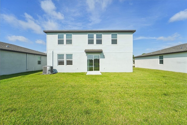 rear view of property featuring central AC unit and a yard