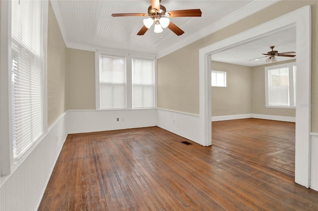 empty room with ceiling fan, dark hardwood / wood-style flooring, and ornamental molding