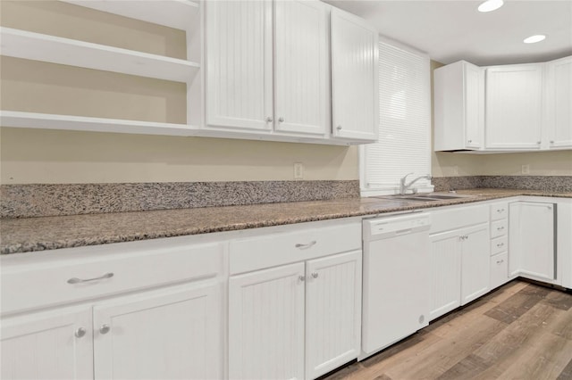 kitchen featuring white cabinetry, dishwasher, and sink