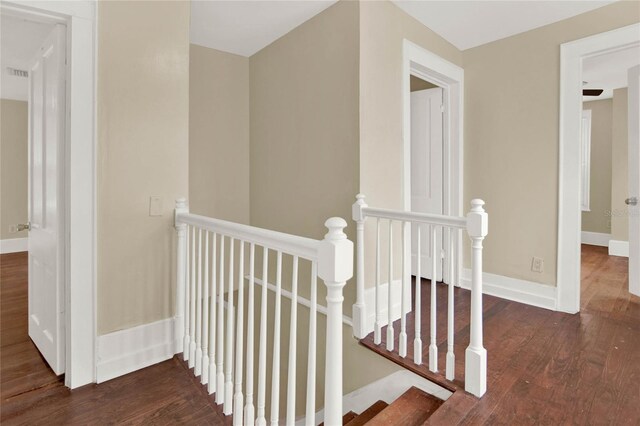 hallway with dark hardwood / wood-style flooring