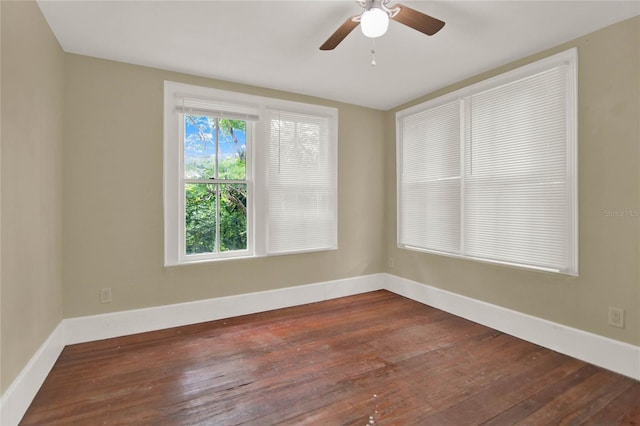 spare room featuring ceiling fan and dark hardwood / wood-style floors