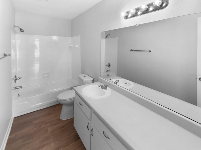 full bathroom with toilet, vanity, hardwood / wood-style flooring, and washtub / shower combination