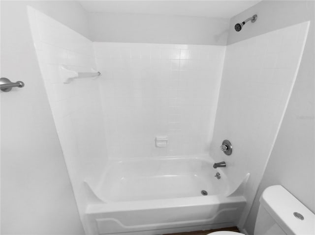 bathroom with shower / bathing tub combination and toilet