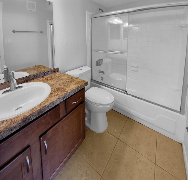 full bathroom with tile patterned flooring, vanity, toilet, and enclosed tub / shower combo