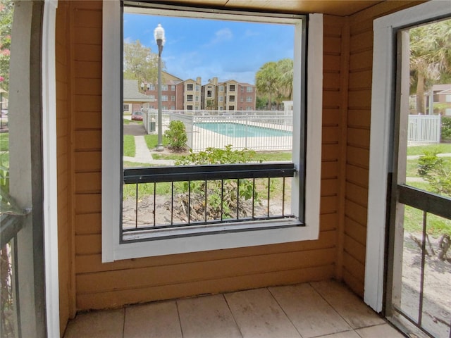 doorway featuring wood walls