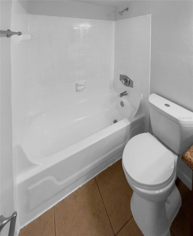 bathroom with tile patterned floors, shower / bath combination, and toilet