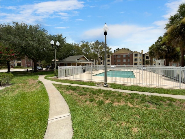 view of swimming pool with a lawn and a patio