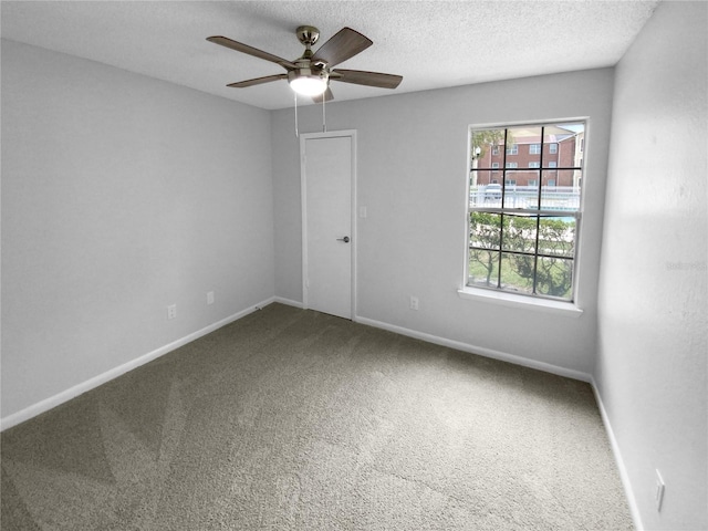 unfurnished room featuring ceiling fan, carpet, and a textured ceiling